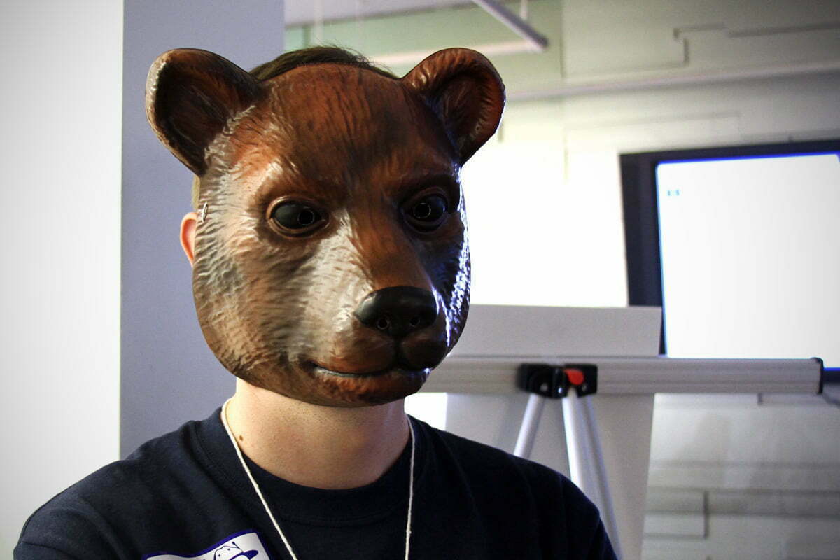 A TransparencyCamp staff member wears a bear mask to scare and entertain campers.
