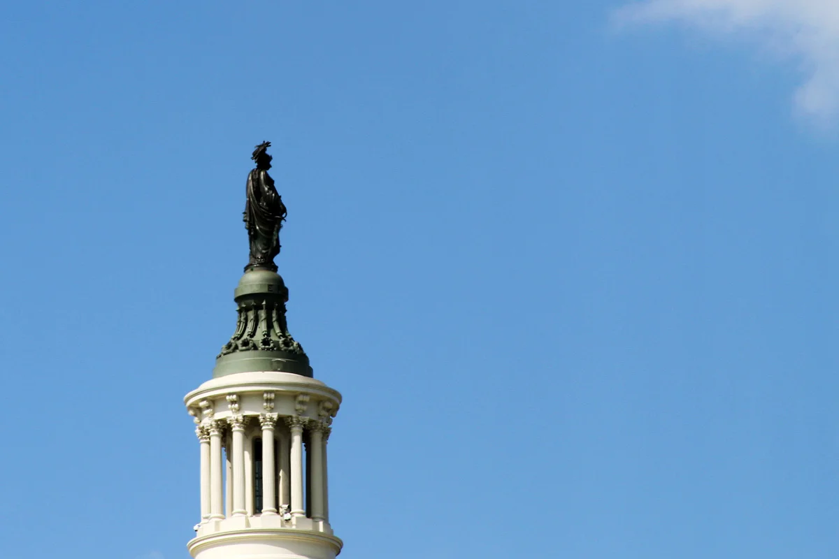 A closeup image of the statue on the top of the US Capitol