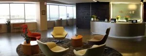 A panorama of the 7th floor lobby in Microsoft's DC office with a desk and office chairs in a circle.