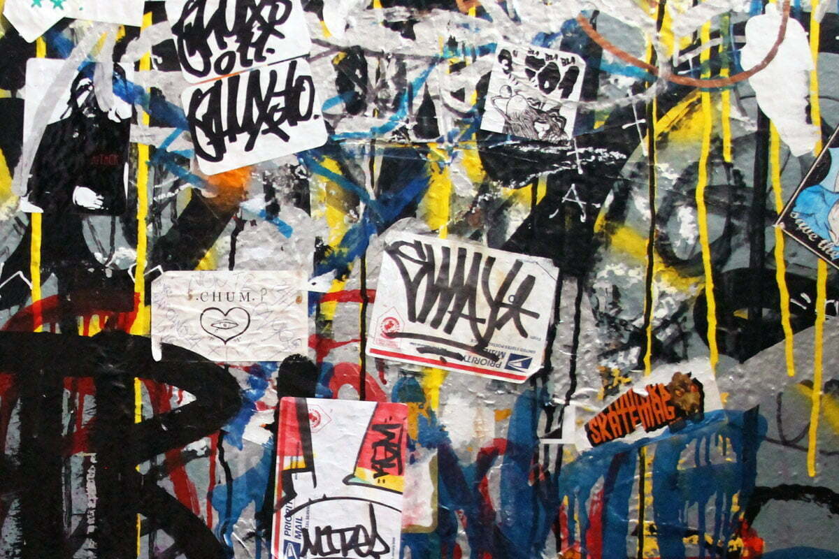 Spray paint, tags and stickers litter a bathroom wall in the Misson district of San Francisco.