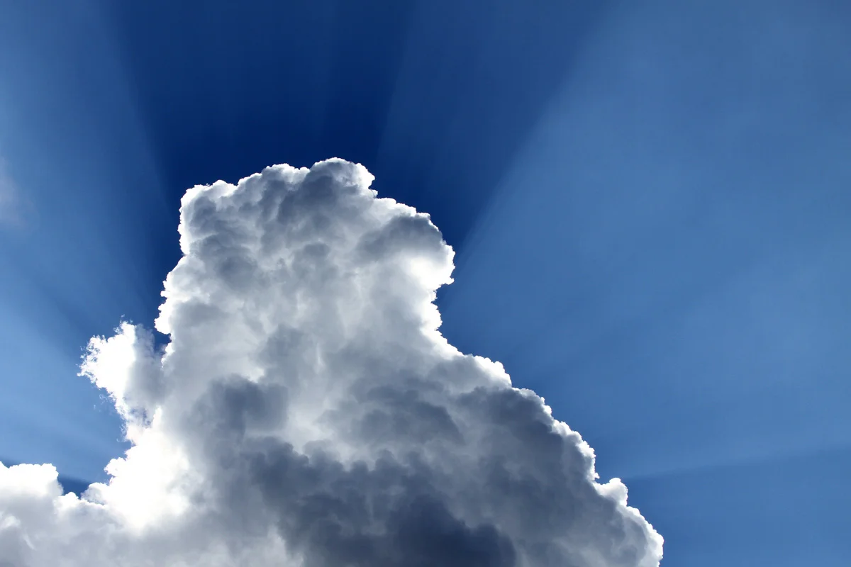 Sunshine cascades around a large cumulus cloud in Luray, Virginia.