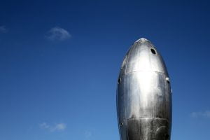 The shining metal surface of the Ray gun gothic rocket ship against a blue sky on Pier 14 in San Francisco.