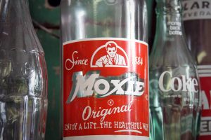 An old glass bottle of the official soft drink of Maine, Moxie Original.