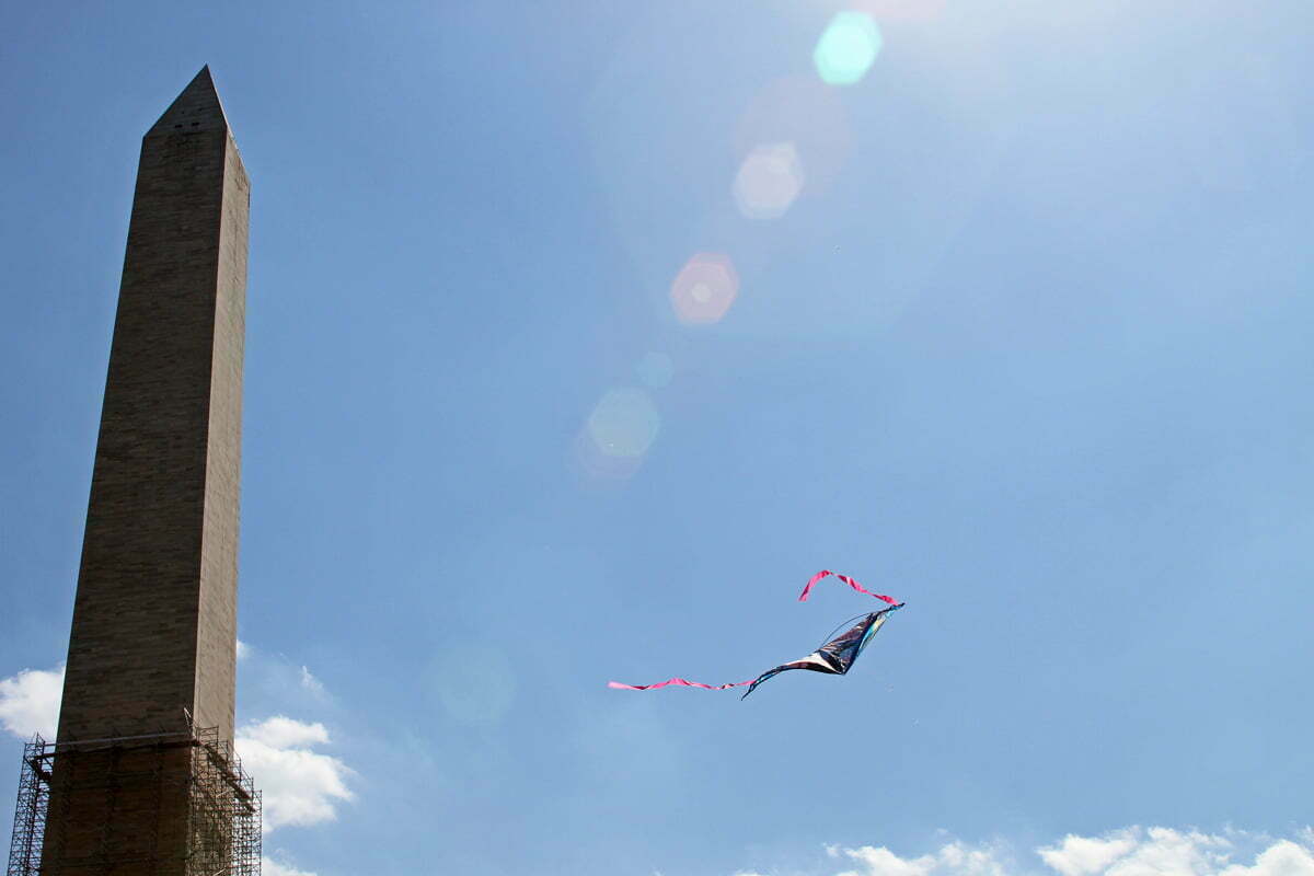 A kite flies near the Washington Monument at the annual Cherry Blossom Kite Festival on the National Mall.