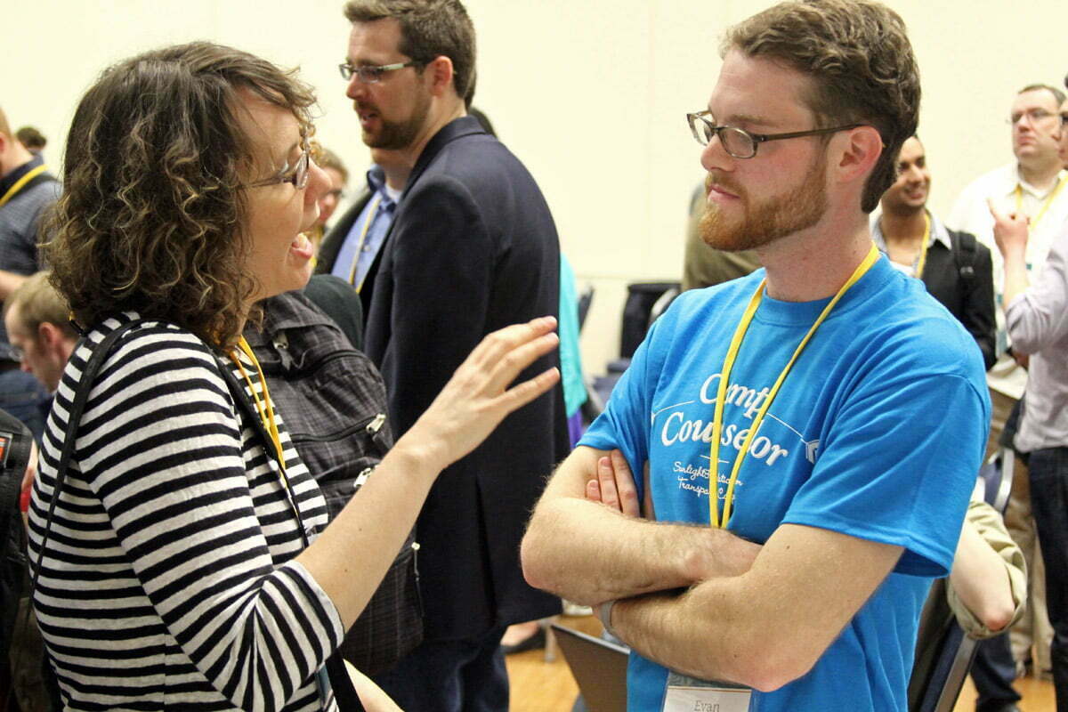 A tcamper talks to a camp counselor following the opening session of the Sunlight Foundation's TransparencyCamp 2013.