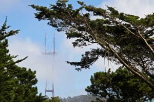 A partially obstructed view of Sutro Tower through some clouds as seen from the top of Strawberry Hill in Golden Gate Park in San Francisco.