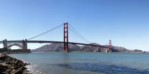 A panoramic image from six different photographs of the Golden Gate Bridge seen from bay level in San Francisco, California.