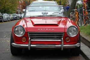 The front grill and headlights on a red 1967 Datsun 1600 Roadster - my favorite car.
