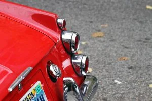 The chrome tail lights on a red 1967 Datsun Roadster 1600.