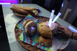 A collection of various types of bread with glow sticks in them from Eric's going away party at the Sunlight Foundation.