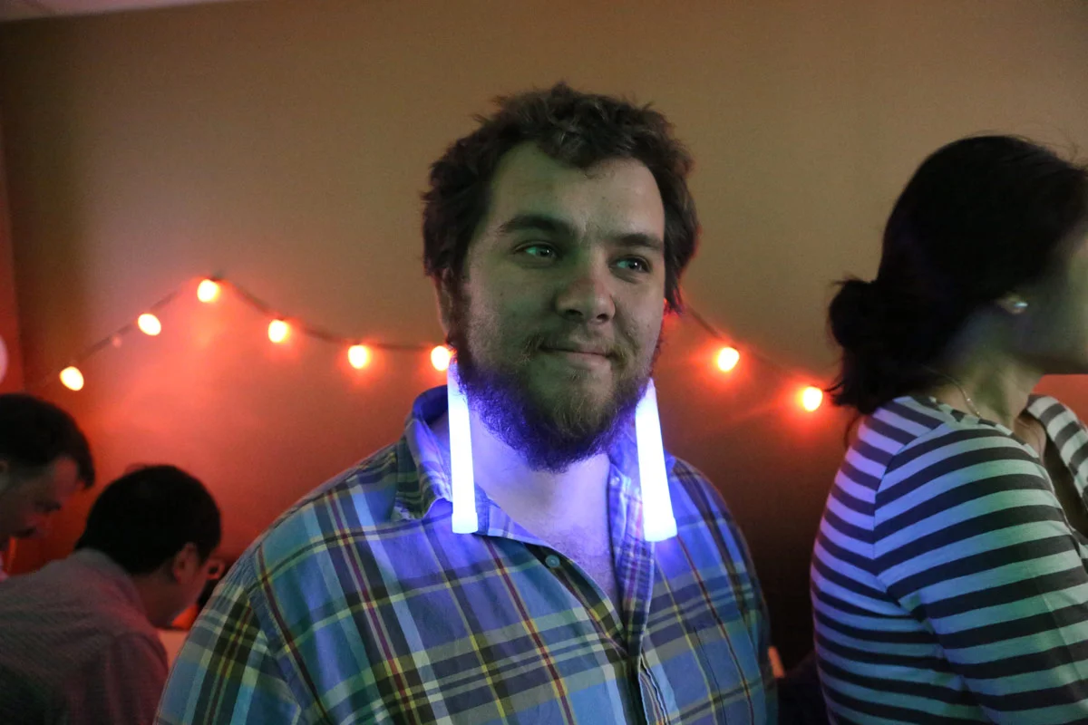 Zander wearing glow stick earrings at the going away party for Eric at the Sunlight Foundation.