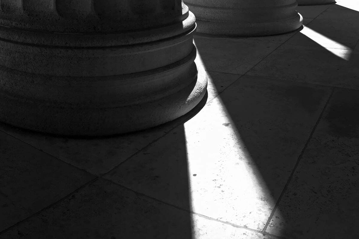 Sunlight casts long shadows through columns at the Philadelphia Museum of Art.