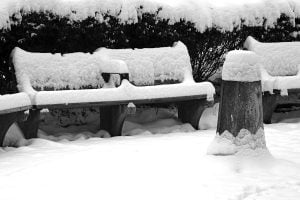 Some park benches and a water fountain covered in snow seen near Kalorama Park in Washington DC.